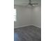 Spacious bedroom with ceiling fan, gray vinyl flooring and large window at 3915 W Robson St, Tampa, FL 33614