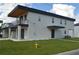 Modern two-story house with a gray facade, dark garage door, and small balcony at 3915 W Robson St, Tampa, FL 33614