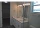 Double vanity bathroom with a walk-in shower and access to a large closet at 3915 W Robson St, Tampa, FL 33614