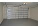 Attached garage with neutral walls and gray epoxy floor at 3915 W Robson St, Tampa, FL 33614
