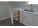White kitchen cabinets with a built-in wood pull-out spice rack at 3915 W Robson St, Tampa, FL 33614