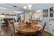 Charming dining room features a round table and chairs, open to living room at 3970 37Th S St # 14, St Petersburg, FL 33711