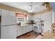 Well-equipped kitchen with white cabinets and granite countertops at 3970 37Th S St # 14, St Petersburg, FL 33711