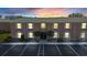 Brick condo building exterior at dusk with parking at 3970 37Th S St # 14, St Petersburg, FL 33711