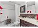 Clean bathroom with white tile, cherry design, and dark vanity at 3970 37Th S St # 14, St Petersburg, FL 33711