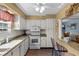 Bright kitchen featuring white cabinets, granite countertops, and microwave at 3970 37Th S St # 14, St Petersburg, FL 33711