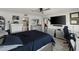 Bedroom features a ceiling fan, a large TV and updated decor at 7600 Sun Island S Dr # 107, South Pasadena, FL 33707