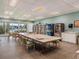 Bright community room featuring a long table, lending library and vending machines at 7600 Sun Island S Dr # 107, South Pasadena, FL 33707