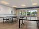 Spacious game room features ping pong tables and sliding glass doors to the outside at 7600 Sun Island S Dr # 107, South Pasadena, FL 33707