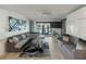Relaxing living area featuring stylish sofas, entertainment center, and water views at 7600 Sun Island S Dr # 107, South Pasadena, FL 33707