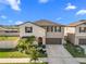 Two story house with a two car garage and landscaping at 8968 Parsons Hill Blvd, Wesley Chapel, FL 33545