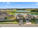 Two story house next to a pond in a residential area at 8968 Parsons Hill Blvd, Wesley Chapel, FL 33545