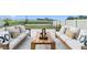 Relaxing patio with wooden furniture and pond view at 8968 Parsons Hill Blvd, Wesley Chapel, FL 33545