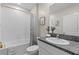Clean bathroom with white subway tile, granite vanity, and tub at 8968 Parsons Hill Blvd, Wesley Chapel, FL 33545