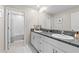 Double vanity bathroom with granite countertops and a tub at 8968 Parsons Hill Blvd, Wesley Chapel, FL 33545