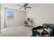 Bedroom with desk, window, and ceiling fan at 8968 Parsons Hill Blvd, Wesley Chapel, FL 33545