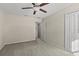Simple bedroom with neutral walls, carpet, and ceiling fan at 8968 Parsons Hill Blvd, Wesley Chapel, FL 33545