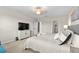 Bright bedroom with carpeted floor and large TV at 8968 Parsons Hill Blvd, Wesley Chapel, FL 33545