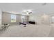 Spacious bonus room with neutral carpeting, ceiling fan, and two windows at 8968 Parsons Hill Blvd, Wesley Chapel, FL 33545