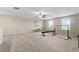Spacious bonus room with carpeted floor and plenty of natural light at 8968 Parsons Hill Blvd, Wesley Chapel, FL 33545
