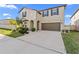 Two-story house with a two-car garage and landscaping at 8968 Parsons Hill Blvd, Wesley Chapel, FL 33545