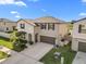 Two-story house with brown roof, attached garage, and landscaping at 8968 Parsons Hill Blvd, Wesley Chapel, FL 33545
