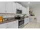 Modern kitchen with white cabinets and granite countertops at 8968 Parsons Hill Blvd, Wesley Chapel, FL 33545