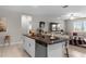 Kitchen island with granite countertop and seating for four at 8968 Parsons Hill Blvd, Wesley Chapel, FL 33545