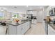 Open kitchen island with granite countertops and stainless steel appliances at 8968 Parsons Hill Blvd, Wesley Chapel, FL 33545