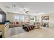 Spacious living room with sectional sofa and large windows at 8968 Parsons Hill Blvd, Wesley Chapel, FL 33545