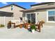 Relaxing patio with wooden furniture and potted plants at 8968 Parsons Hill Blvd, Wesley Chapel, FL 33545