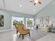 Bright living room featuring vaulted ceilings, beige sofa, and two armchairs at 1580 Mac Chesney Dr, Tarpon Springs, FL 34689