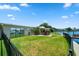 Landscaped backyard with a covered patio and a water view at 17444 2Nd E St, Redington Shores, FL 33708