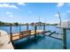 Private wooden dock with boat lift, offering convenient water access at 17444 2Nd E St, Redington Shores, FL 33708
