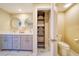 Main bathroom with dual sinks, a toilet, and built-in shelving at 17444 2Nd E St, Redington Shores, FL 33708
