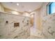 Walk-in shower with marble tile and multiple shower heads at 17444 2Nd E St, Redington Shores, FL 33708