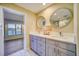 Elegant bathroom with dual sinks, large mirrors, and a walk-in shower at 17444 2Nd E St, Redington Shores, FL 33708
