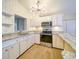 Modern kitchen with granite countertops and white cabinets at 17444 2Nd E St, Redington Shores, FL 33708
