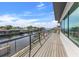 Enjoy water views from this spacious wooden balcony with a glass railing and exterior access at 1954 Iowa Ne Ave, St Petersburg, FL 33703