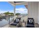 Scenic balcony overlooking waterfront, with chairs and glass railing at 1954 Iowa Ne Ave, St Petersburg, FL 33703