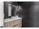 Modern powder room features textured gray walls, a contemporary vessel sink, and stylish lighting fixtures at 1954 Iowa Ne Ave, St Petersburg, FL 33703