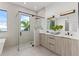 Modern bathroom featuring a dual vanity, sleek glass shower, and contemporary design at 1954 Iowa Ne Ave, St Petersburg, FL 33703