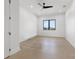 Bright bedroom with hardwood floors, black window trim, and a ceiling fan at 1954 Iowa Ne Ave, St Petersburg, FL 33703