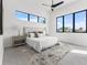Bright bedroom with many windows, a ceiling fan, and an area rug under the queen bed at 1954 Iowa Ne Ave, St Petersburg, FL 33703