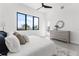 Airy bedroom with neutral decor, modern furnishings, and tranquil water view from a large window at 1954 Iowa Ne Ave, St Petersburg, FL 33703
