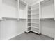 Walk-in closet with multiple tiers of white shelving units at 1954 Iowa Ne Ave, St Petersburg, FL 33703