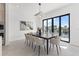 Stylish dining room with a sleek black table, designer lighting, and a picturesque canal view at 1954 Iowa Ne Ave, St Petersburg, FL 33703
