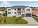 Stunning two-story home with manicured lawn, sleek black garage doors and modern architectural details at 1954 Iowa Ne Ave, St Petersburg, FL 33703