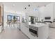 Spacious modern kitchen with quartz countertops, an island with seating, and an open layout into the living area at 1954 Iowa Ne Ave, St Petersburg, FL 33703