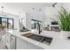 Bright modern kitchen with a large island featuring a sink, light cabinets, and high-end appliances at 1954 Iowa Ne Ave, St Petersburg, FL 33703